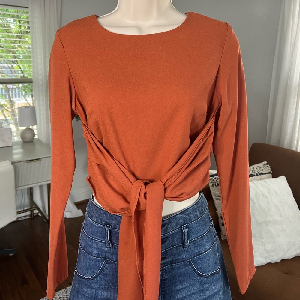 Size small burnt orange crop top with tie detailing in front and zip up back